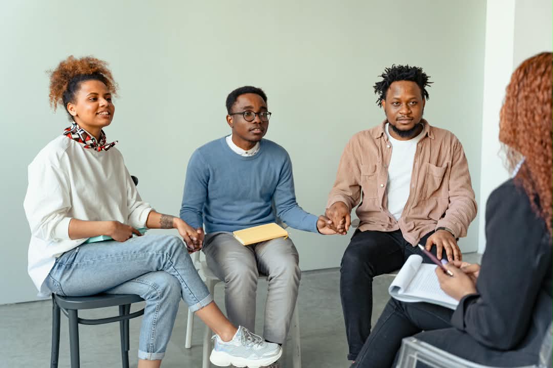 Community members seated in a facilitated dialogue circle